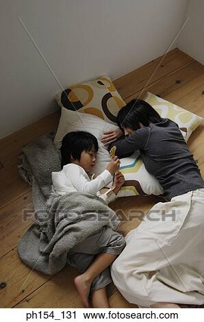 High angle view of a mid adult woman and her son sleeping View Large Photo Image Stock Image - High angle view of a mid adult woman and her son sleeping. Fotosearch