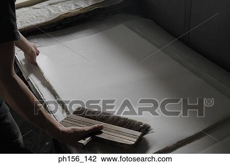 High angle view of a person's hand holding a sheet of paper and a brush View Large Photo Image Stock Image - High angle view of a person's hand holding a sheet of paper and a brush. Fotosearch