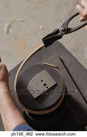 High angle view of a person's hand bending a wooden strip with the help of a pair of pliers View Large Photo Image Stock Image - High angle view of a person's hand bending a wooden strip with the help of a pair of pliers. Fotosearch