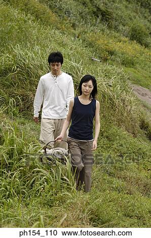 Stock Image - High angle view of a young couple walking. Fotosearch