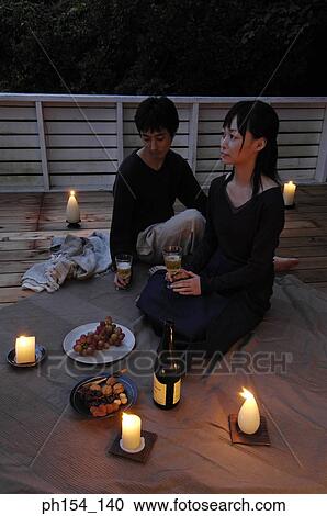 Stock Image - High angle view of a young couple celebrating. Fotosearch