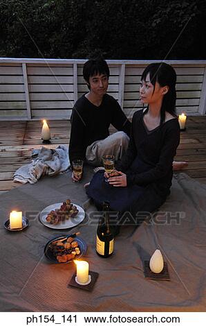 Stock Image - High angle view of a young couple celebrating. Fotosearch