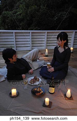 High angle view of a young couple celebrating View Large Photo Image Stock Photo - High angle view of a young couple celebrating. Fotosearch
