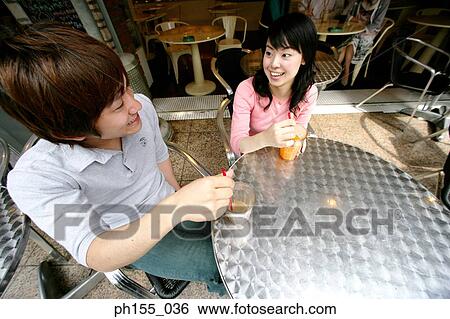 High angle view of a young couple sitting together in a restaurant and smiling View Large Photo Image Stock Photograph - High angle view of a young couple sitting together in a restaurant and smiling. Fotosearch