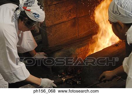 High angle view of two blacksmiths working near a furnace View Large Photo Image Stock Photo - High angle view of two blacksmiths working near a furnace. Fotosearch