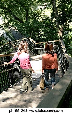 High angle view of two women walking down steps View Large Photo Image Stock Photo - High angle view of two women walking down steps. Fotosearch