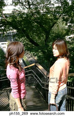High angle view of two young women standing on steps View Large Photo Image Stock Photo - High angle view of two young women standing on steps. Fotosearch