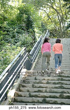 Low angle view of two women walking up steps View Large Photo Image Stock Photography - Low angle view of two women walking up steps. Fotosearch