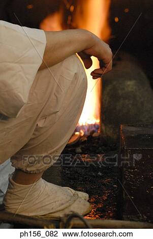 Low section view of a blacksmith sitting near a furnace View Large Photo Image Stock Image - Low section view of a blacksmith sitting near a furnace. Fotosearch
