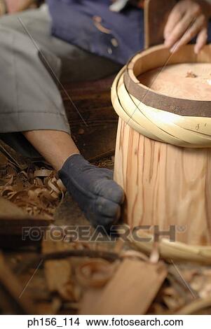 Low section view of a carpenter fixing cane on a barrel View Large Photo Image Picture - Low section view of a carpenter fixing cane on a barrel. Fotosearch
