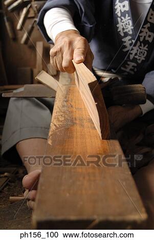 Low section view of a carpenter holding a piece of wood View Large Photo Image Stock Image - Low section view of a carpenter holding a piece of wood. Fotosearch
