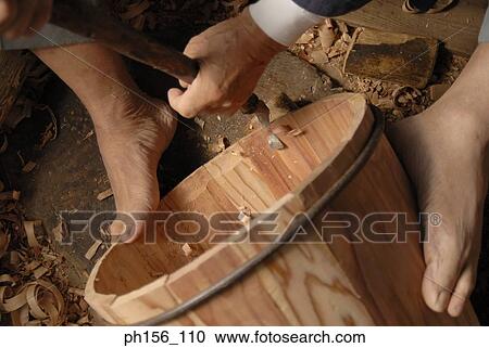 Stock Image - Low section view of a carpenter making a barrel. Fotosearch