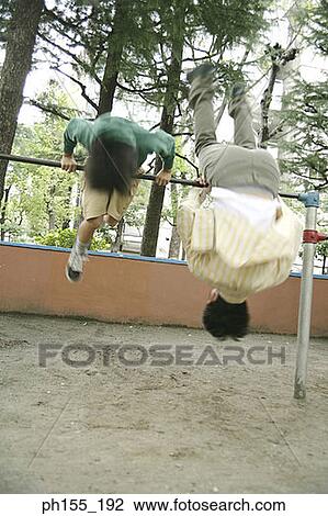 Man with his son hanging on monkey bars View Large Photo Image Stock Image - Man with his son hanging on monkey bars. Fotosearch