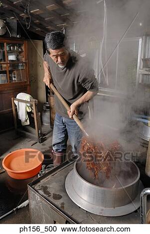 Mature man boiling dye in a container View Large Photo Image Stock Image - Mature man boiling dye in a container. Fotosearch