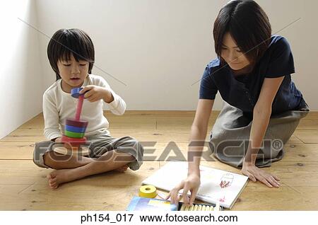 Mid adult woman playing with her daughter View Large Photo Image Stock Photo - Mid adult woman playing with her daughter. Fotosearch