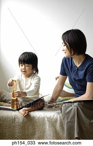 Mid adult woman teaching her daughter View Large Photo Image Stock Image - Mid adult woman teaching her daughter. Fotosearch