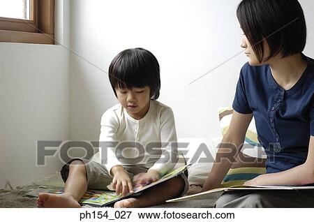 Mid adult woman teaching her daughter View Large Photo Image Stock Photo - Mid adult woman teaching her daughter. Fotosearch