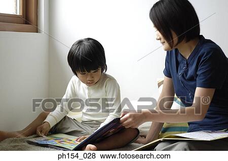 Mid adult woman teaching her daughter View Large Photo Image Stock Photo - Mid adult woman teaching her daughter. Fotosearch