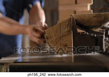 Mid section view of a carpenter cutting wood in a workshop View Large Photo Image Stock Image - Mid section view of a carpenter cutting wood in a workshop. Fotosearch