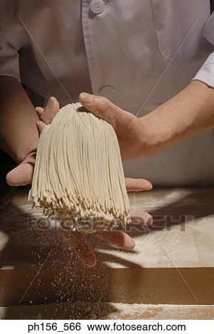Mid section view of a chef holding and shaking raw noodles View Large Photo Image Stock Photograph - Mid section view of a chef holding and shaking raw noodles. Fotosearch