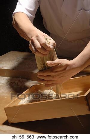Mid section view of a chef putting raw noodles in a tray View Large Photo Image Stock Image - Mid section view of a chef putting raw noodles in a tray. Fotosearch