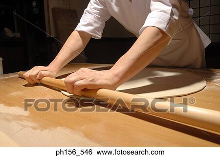 Mid section view of a chef rolling dough View Large Photo Image Stock Photograph - Mid section view of a chef rolling dough. Fotosearch