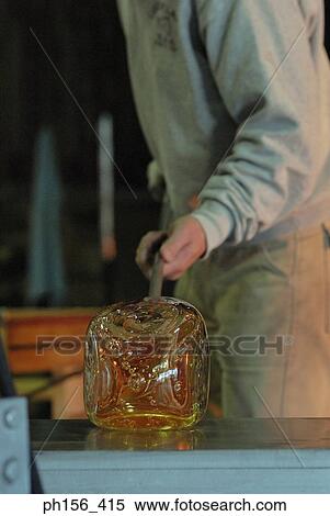 Mid section view of a man blowing molten glass with the help of a blow pipe View Large Photo Image Stock Photography - Mid section view of a man blowing molten glass with the help of a blow pipe. Fotosearch