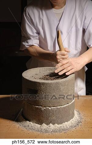 Mid section view of a man grinding grain in a grinding stone View Large Photo Image Stock Image - Mid section view of a man grinding grain in a grinding stone. Fotosearch