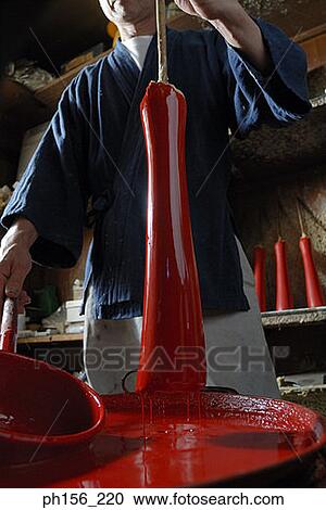 Mid section view of a person holding a candle dipped in paint View Large Photo Image Stock Image - Mid section view of a person holding a candle dipped in paint. Fotosearch
