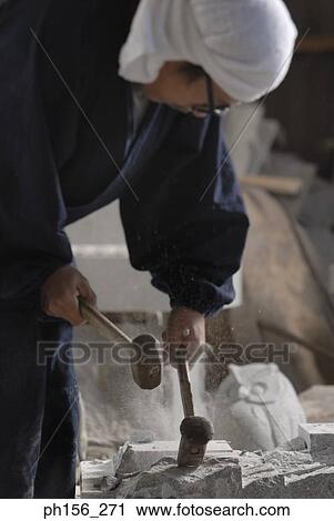 Mid section view of a sculptor carving stone with hammers View Large Photo Image Stock Image - Mid section view of a sculptor carving stone with hammers. Fotosearch