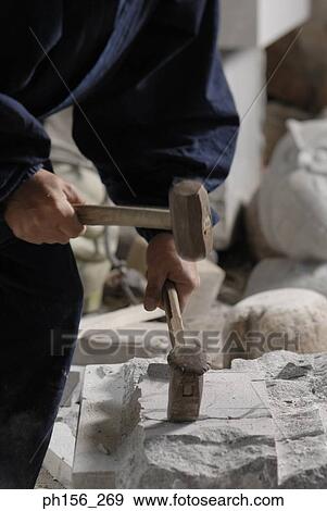 Mid section view of a sculptor carving stone with hammers View Large Photo Image Stock Photo - Mid section view of a sculptor carving stone with hammers. Fotosearch