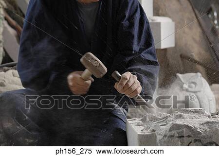 Mid section view of a sculptor carving stone with a chisel and a hammer View Large Photo Image Stock Photography - Mid section view of a sculptor carving stone with a chisel and a hammer. Fotosearch