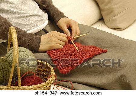 Stock Photo - Mid section view of a woman knitting. Fotosearch