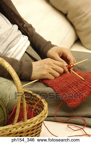 Mid section view of a woman knitting View Large Photo Image Stock Photograph - Mid section view of a woman knitting. Fotosearch