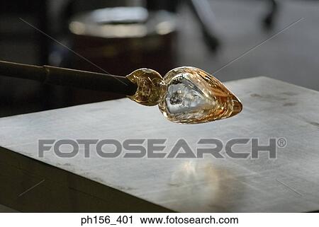 Molten glass at the end of a blow pipe View Large Photo Image Stock Image - Molten glass at the end of a blow pipe. Fotosearch