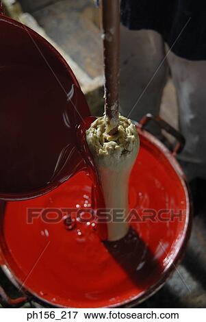 Stock Photo - Paint being poured on a candle. Fotosearch