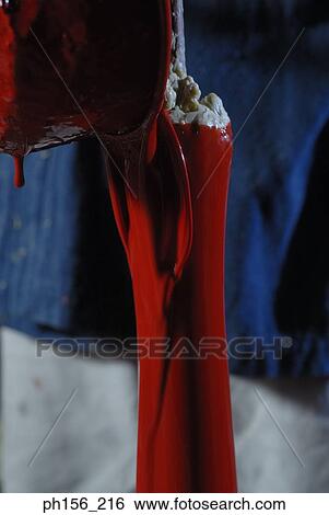 Paint being poured on a candle View Large Photo Image Stock Photograph - Paint being poured on a candle. Fotosearch