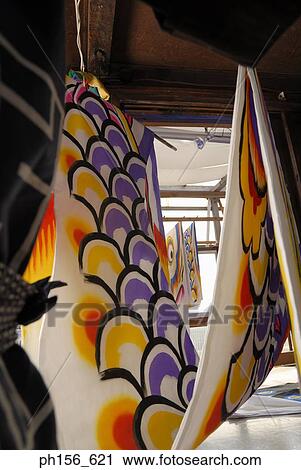 Stock Image - Painted sheets hanging in a workshop. Fotosearch
