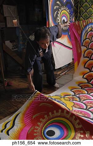 Painter picking a painted sheet in a workshop View Large Photo Image Picture - Painter picking a painted sheet in a workshop. Fotosearch