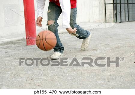 Stock Image - Person playing basketball. Fotosearch