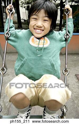 Portrait of a boy sitting on a swing View Large Photo Image Stock Image - Portrait of a boy sitting on a swing. Fotosearch