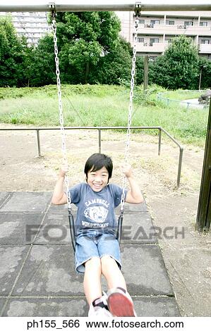 Portrait of a boy smiling on a swing View Large Photo Image Stock Photograph - Portrait of a boy smiling on a swing. Fotosearch