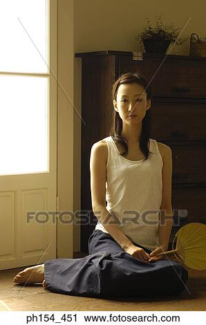 Portrait of a young woman holding a fan View Large Photo Image Stock Image - Portrait of a young woman holding a fan. Fotosearch