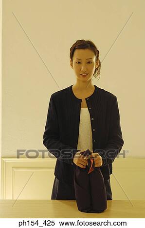 Portrait of a young woman holding two bottles wrapped in a cloth View Large Photo Image Stock Photography - Portrait of a young woman holding two bottles wrapped in a cloth. Fotosearch