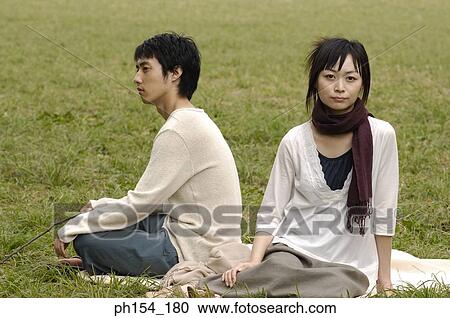Portrait of a young woman sitting with a young man View Large Photo Image Stock Image - Portrait of a young woman sitting with a young man. Fotosearch