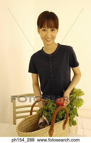 Stock Photo - Portrait of a young woman smiling. Fotosearch