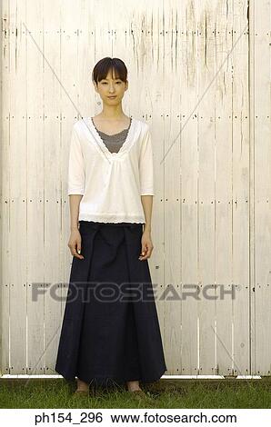 Portrait of a young woman standing View Large Photo Image Stock Photograph - Portrait of a young woman standing. Fotosearch
