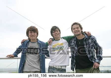 Portrait of three young men standing together View Large Photo Image Stock Photograph - Portrait of three young men standing together. Fotosearch