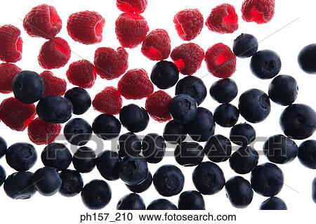 Stock Image - Raspberries and blueberries. Fotosearch