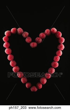 Stock Image - Raspberries in a heart shape. Fotosearch